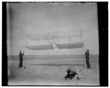 TITLE:  [1901 glider being flown as a kite, Wilbur at left side, Orville at right; Kitty Hawk, North Carolina]
CALL NUMBER:  LC-W85- 112 [P&P] REPRODUCTION NUMBER:  LC-DIG-ppprs-00571 (digital file from original) LC-W851-112 (b&w film copy neg.) CREATED/PUBLISHED:  [1901]
PART OF:  Glass negatives from the Papers of Wilbur and Orville Wright REPOSITORY:  Library of Congress Prints and Photographs Division Washington, D.C. 20540 USA