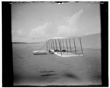 TITLE:  [Wilbur Wright in prone position on glider just after landing, its skid marks visible behind it and, in the foreground, skid marks from a previous landing; Kitty Hawk, North Carolina]
CALL NUMBER:  LC-W85- 111 [P&P] REPRODUCTION NUMBER:  LC-DIG-ppprs-00570 (digital file from original) LC-W851-111 (b&w film copy neg.) CREATED/PUBLISHED:  [1901]
PART OF:  Glass negatives from the Papers of Wilbur and Orville Wright REPOSITORY:  Library of Congress Prints and Photographs Division Washington, D.C. 20540 USA